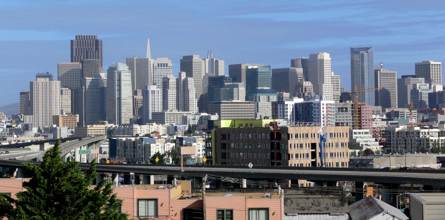 The San Francisco skyline seen from Potrero Hill, with mid-rise construction and a tower crane in the foreground